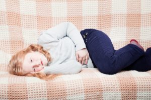 Toddler lying on couch sick