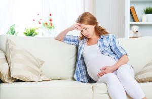 Pregnant woman laying on couch