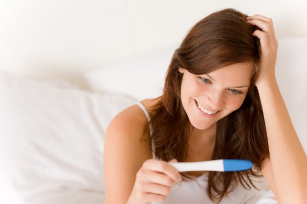 Pregnancy test - happy surprised woman, positive result