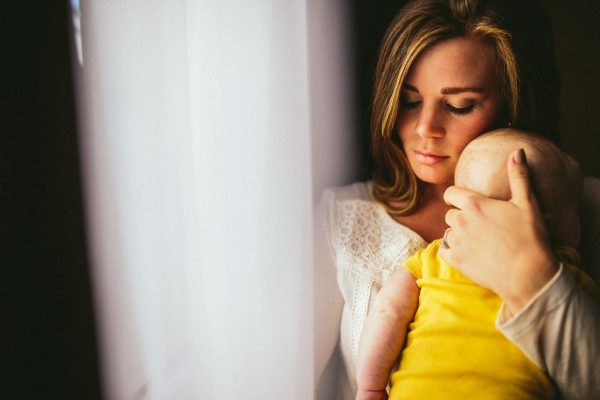 Women holding her baby - Postpartum Depression